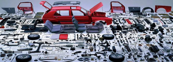 Detailed view of various car accessories and parts laid out for assembly or repair, including panels, wheels, and interior fittings, highlighting essential items used in vehicle enhancement and mainte.